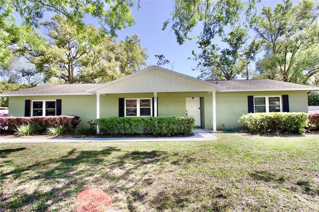 ranch-style home with brick siding and a front lawn