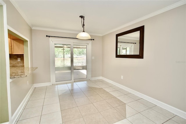 spare room with crown molding, light tile patterned floors, and baseboards