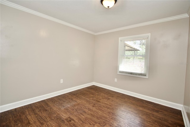 spare room with baseboards, dark wood finished floors, and ornamental molding