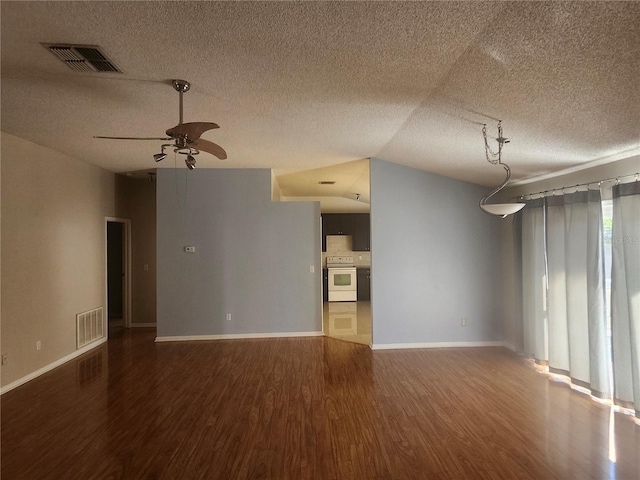 unfurnished living room featuring visible vents, baseboards, ceiling fan, and wood finished floors