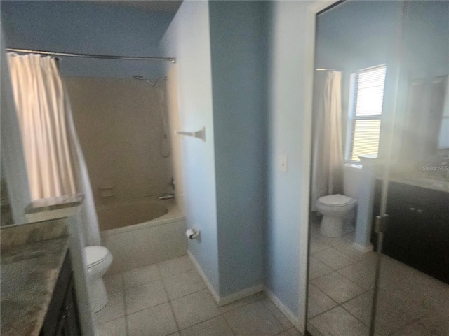 full bathroom featuring vanity, tile patterned floors, toilet, and shower / bath combo with shower curtain