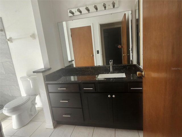 bathroom with tile patterned floors, toilet, and vanity