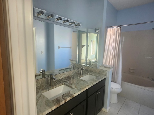 bathroom with tile patterned flooring, toilet, and a sink