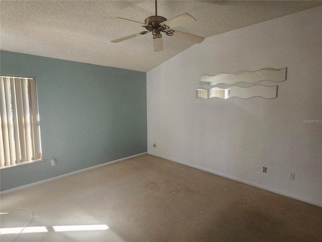 carpeted spare room featuring baseboards, a textured ceiling, and ceiling fan