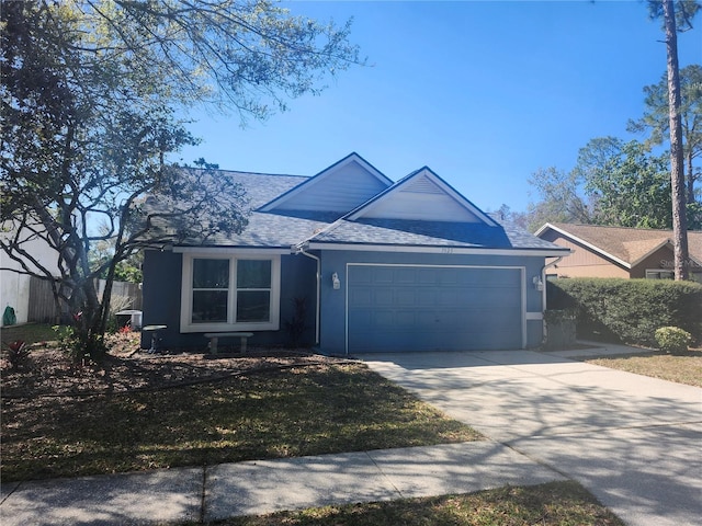 ranch-style house featuring fence, roof with shingles, stucco siding, a garage, and driveway