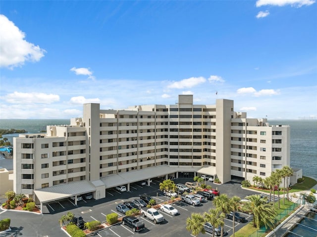 view of property featuring uncovered parking and a water view