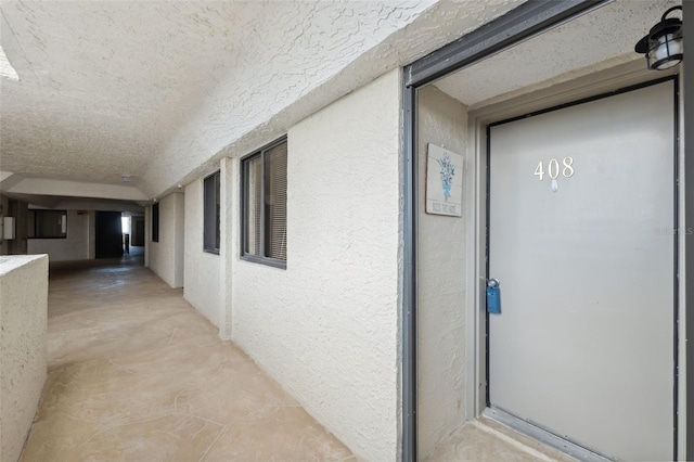 view of exterior entry featuring stucco siding