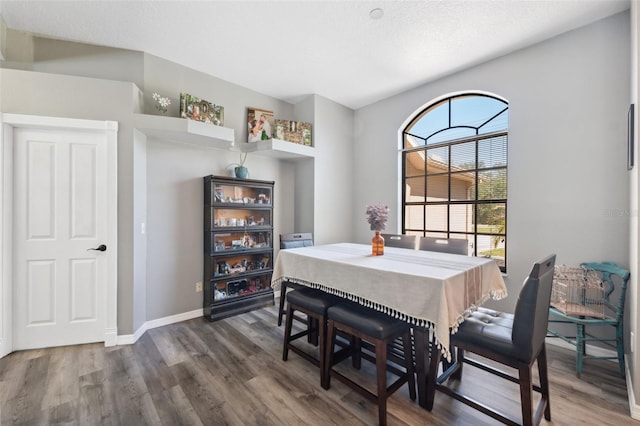 dining room featuring baseboards and wood finished floors