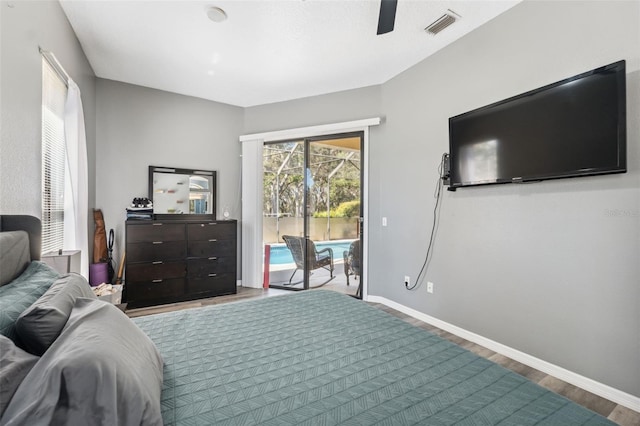 bedroom featuring a ceiling fan, wood finished floors, visible vents, baseboards, and access to outside