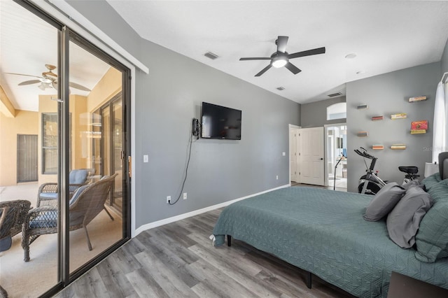 bedroom featuring ceiling fan, visible vents, baseboards, and wood finished floors