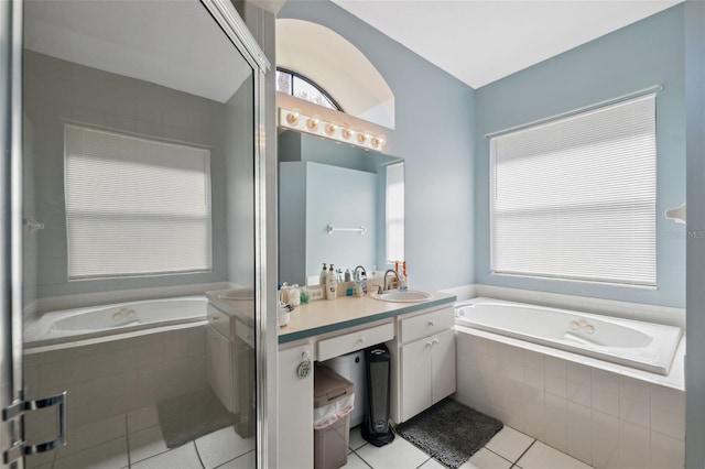 full bathroom with vanity, a bath, a healthy amount of sunlight, and tile patterned flooring