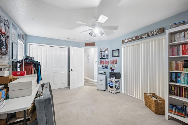 carpeted home office with ceiling fan