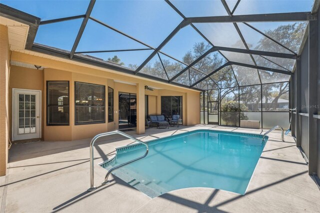 outdoor pool with a patio and a lanai