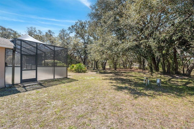 view of yard featuring glass enclosure