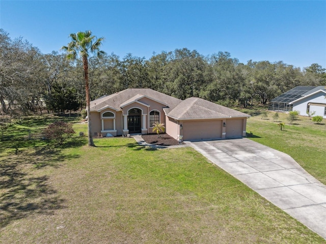 view of front of house with a garage, stucco siding, concrete driveway, and a front lawn