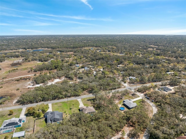 drone / aerial view featuring a forest view