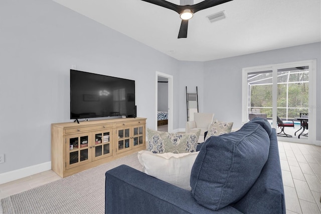 living room featuring wood finished floors, visible vents, baseboards, and ceiling fan