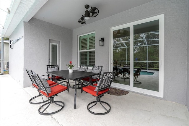 view of patio featuring outdoor dining area and ceiling fan