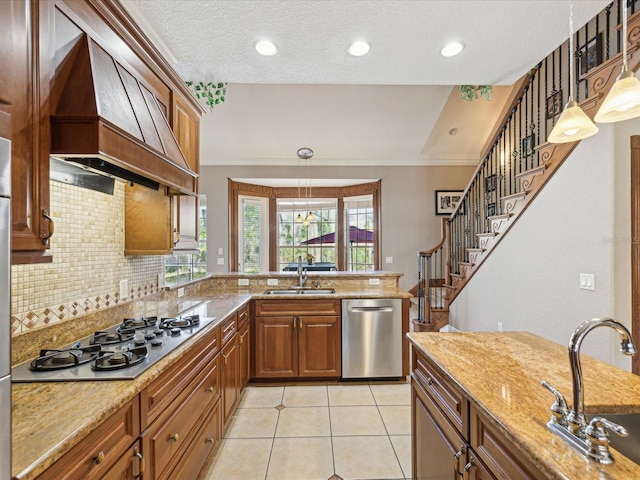 kitchen with a sink, custom range hood, light tile patterned floors, and stainless steel appliances