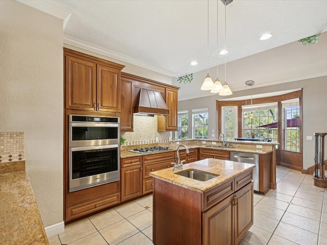 kitchen featuring a sink, appliances with stainless steel finishes, brown cabinetry, and custom range hood