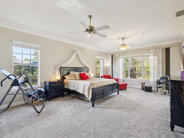 bedroom featuring visible vents, carpet flooring, and crown molding