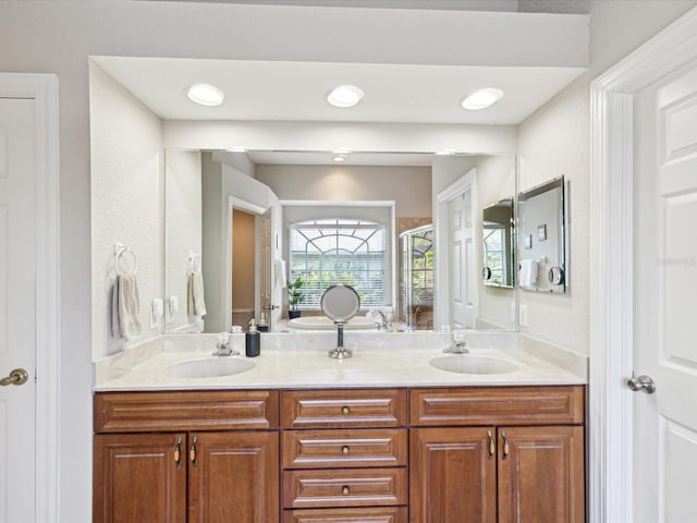 full bath with double vanity and a sink