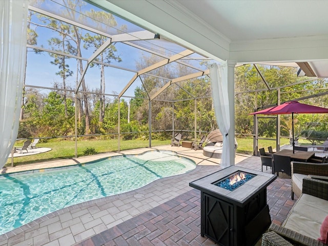 pool with an outdoor living space with a fire pit, a lanai, and a patio area