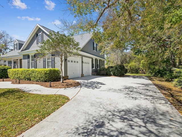 view of side of home featuring driveway and a garage