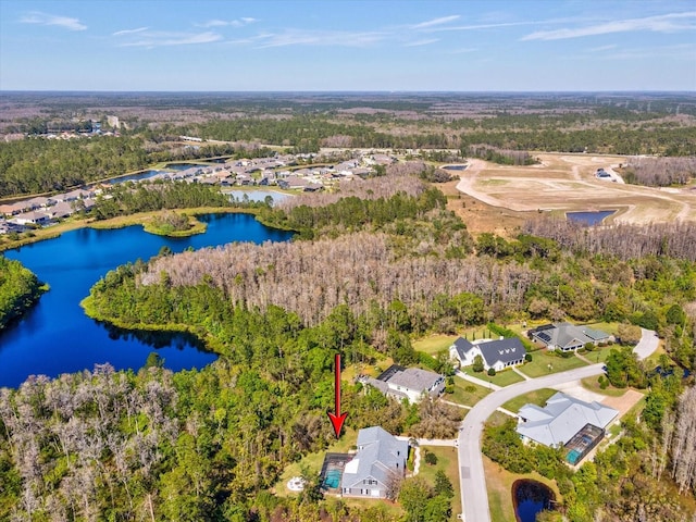 bird's eye view featuring a forest view and a water view