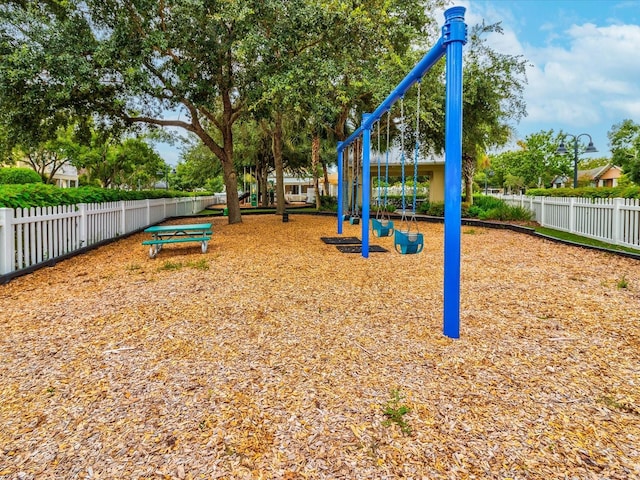 communal playground featuring fence