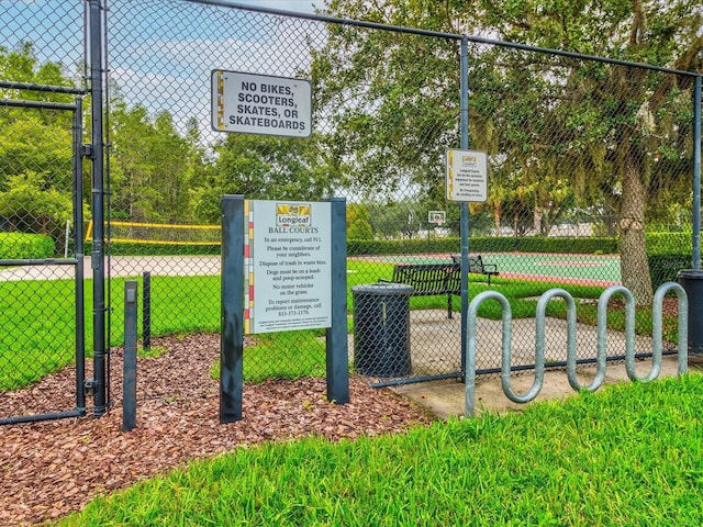 view of community with a yard and fence