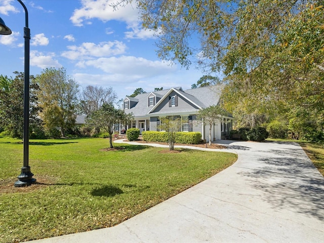 view of front of house featuring concrete driveway, a garage, and a front lawn