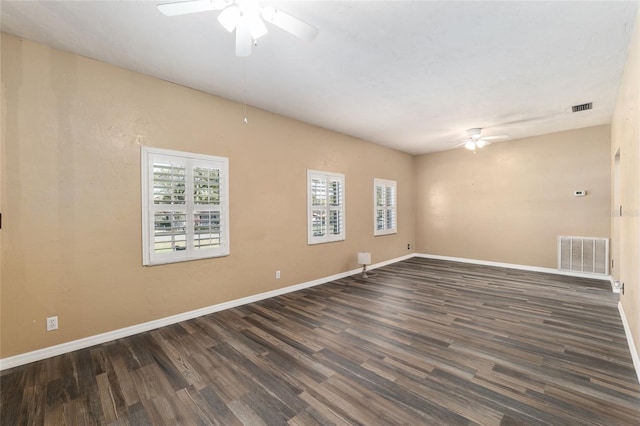 unfurnished room with visible vents, baseboards, wood finished floors, and a ceiling fan