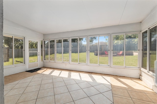 unfurnished sunroom with a wealth of natural light and vaulted ceiling