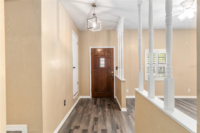 entrance foyer featuring baseboards and dark wood finished floors