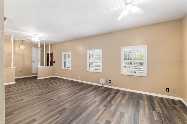 empty room featuring baseboards, a ceiling fan, and wood finished floors