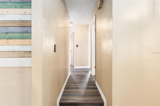 hallway with baseboards and wood finished floors