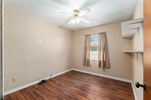 spare room featuring ceiling fan, baseboards, and wood finished floors