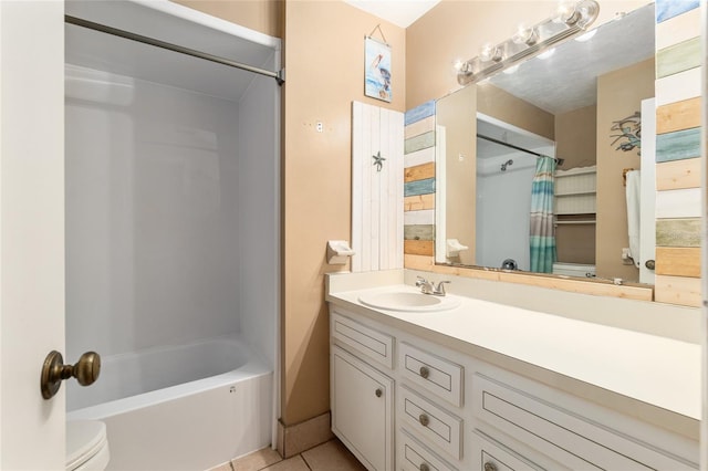 bathroom with tile patterned floors, shower / bathtub combination with curtain, toilet, and vanity