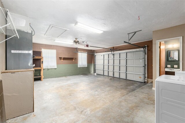 garage with washer / dryer and concrete block wall