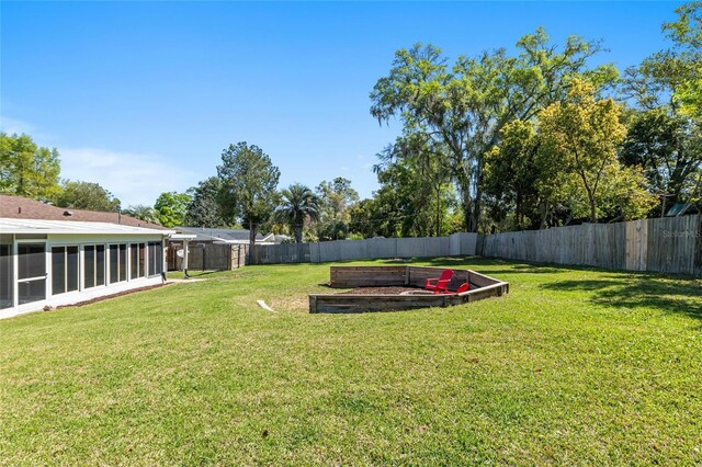 view of yard with a fenced backyard and a sunroom