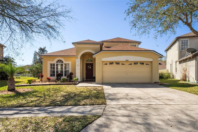 mediterranean / spanish home with stucco siding, an attached garage, concrete driveway, and a front yard