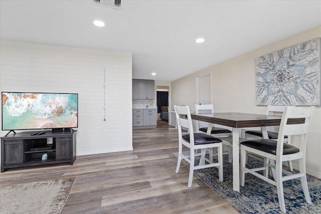 dining area featuring visible vents, recessed lighting, and wood finished floors