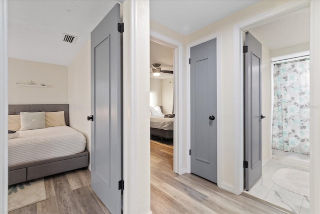 bedroom featuring light wood finished floors and visible vents