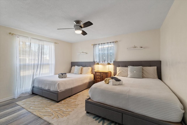 bedroom featuring a ceiling fan and wood finished floors