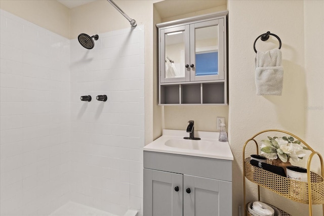 bathroom featuring vanity and a tile shower