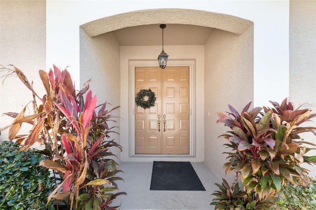 property entrance featuring stucco siding