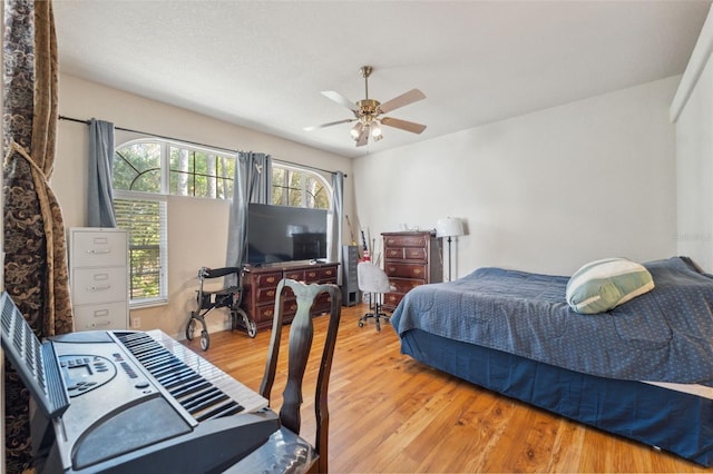 bedroom with wood finished floors and a ceiling fan