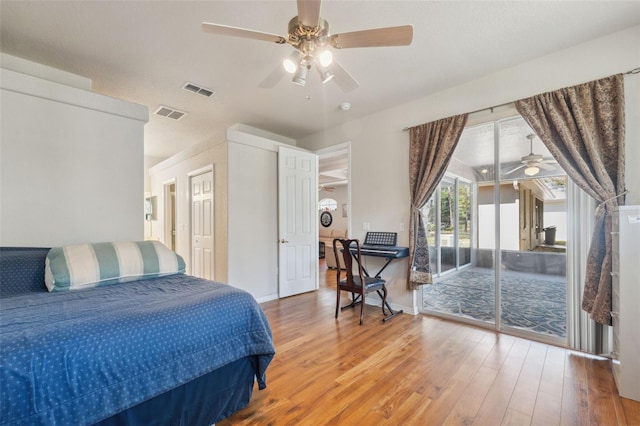 bedroom featuring visible vents, baseboards, wood finished floors, and access to outside