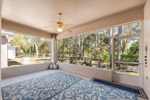 unfurnished sunroom featuring ceiling fan
